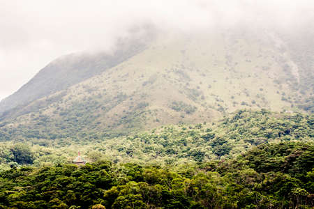 Mountains with early morning mist and a temple in Hong Kong
