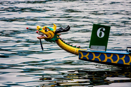 Head of a dragon boat in the waterの写真素材