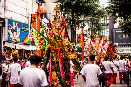 Taipei, Taiwan - 6 October, 2012: Masked creatures walking through the streets downtown during a parade to mark the anniversary of National Dayのeditorial素材