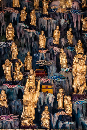 Many golden Buddha statues depicting scenes from his lifeのeditorial素材