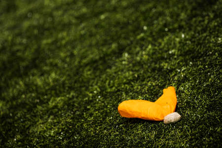 Penalty flag on the grass at an Americal football gameの写真素材
