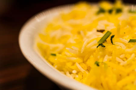 Traditional Indian dish of rice pilaf in white bowlの写真素材