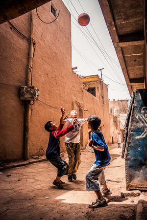 Kashgar, China - 27 June, 2009: Children playing basketball  in the historic old town district of Kashgar during the daytimeのeditorial素材