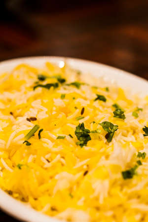 Traditional Indian dish of rice pilaf in white bowl