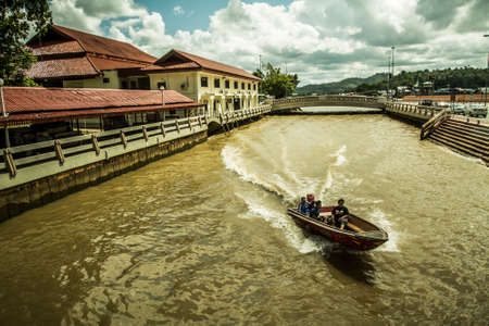 Bandar Seri Begawan, Brunei - 3 December, 2009: Boats passing through a canal near the waterfront in the central district of the cityのeditorial素材