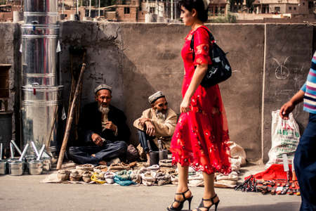 Kashgar, China - 28 June, 2009: Old Uyghur men selling spices on the side of a small road at the Sunday Market in old town Kashgarのeditorial素材