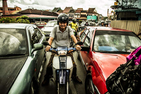 Kuching, Malaysia - 26 November, 2009: Street in the downtown district of the city on an overcast...
