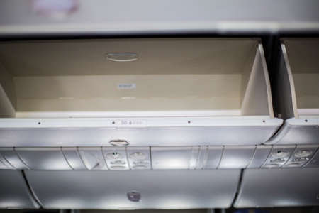 Overhead luggage compartment on a modern commercial airlinerの写真素材
