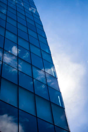 Modern office building against blue sky with small cloudsのeditorial素材