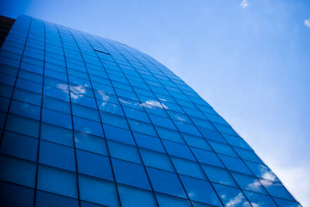 Modern office building against blue sky with small cloudsのeditorial素材