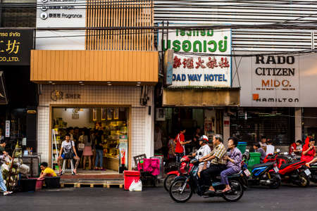 Bangkok, Thailand - 25 February, 2017: People, Motorbikes and Tuk-Tuks on the Yarowat Road, also known as Chinatown, in the late afternoonのeditorial素材