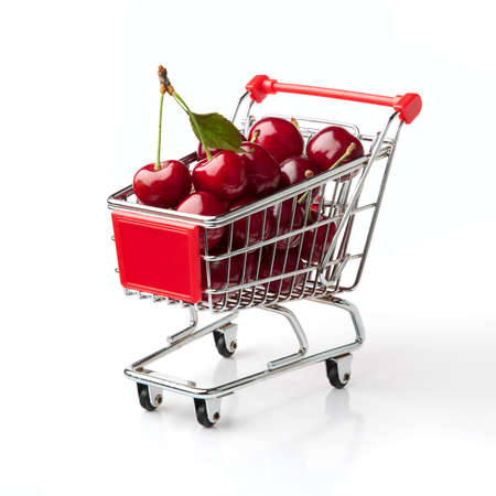 Cherries in Shopping Cart Shopping Cart Isolated On White Backgroundの写真素材