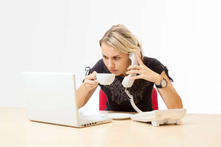 Businesswoman with a telephone in the officeの写真素材