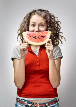 Cheerful Young Woman Holding Watermelonの写真素材