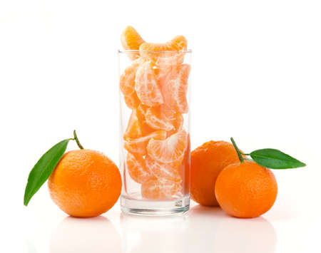 Fresh Tangerine and Segments in a Glass Isolated on Whiteの写真素材