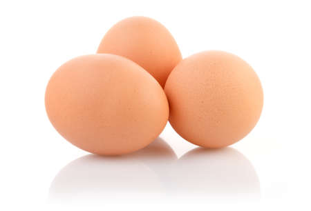Three brown eggs on white background with clipping pathの写真素材