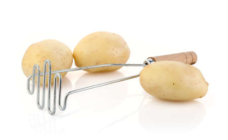 Potatoes with Potato Masher isolated on white backgroundの写真素材