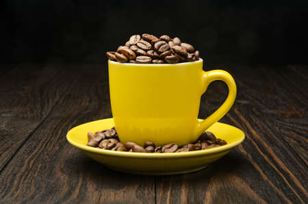 Coffee Beans in a Cup on old wood backgroundの写真素材