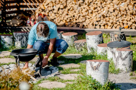 Man at a barbecue grill with smokeの写真素材