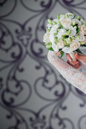 Beautiful wedding bouquet in hands of the brideの写真素材