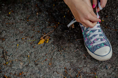 female feet in jeans and sneakersの写真素材