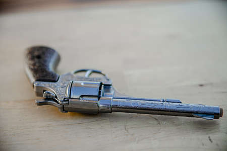vintage gun lying on a wooden table