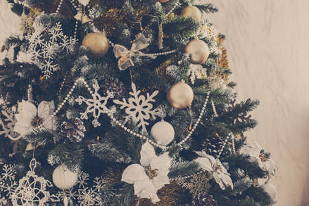Christmas toys on a Christmas tree under snowの写真素材