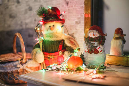 Wreath with snowman sitting on it with text Merry Christmas in vintage styleの写真素材