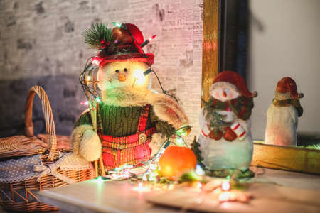 Wreath with snowman sitting on it with text Merry Christmas in vintage styleの写真素材