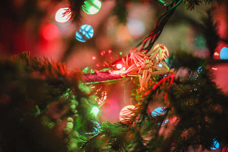 Decorated Christmas tree on  blurred, sparkling and fairy background