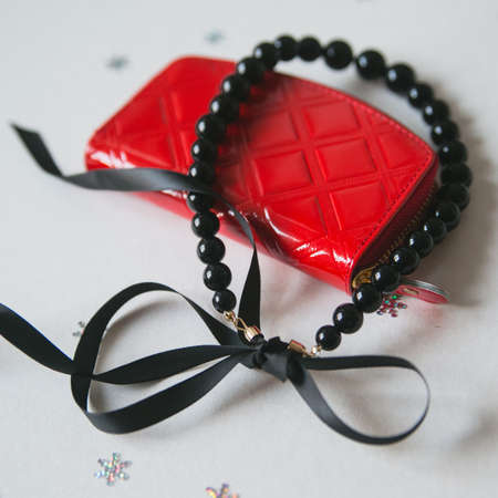 red bag and jewelry, women's accessories in the backgroundの写真素材