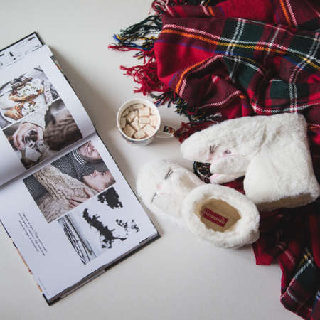 Slippers lie on the background with the magazine and cocoaの写真素材