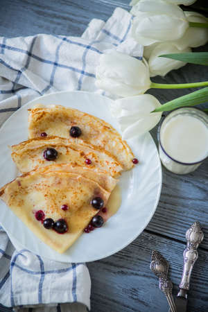 on wooden white background pancakes on a plateの写真素材