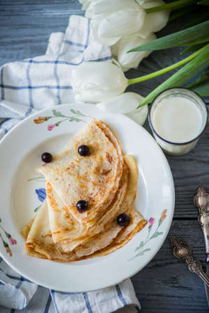on wooden white background pancakes on a plateの写真素材