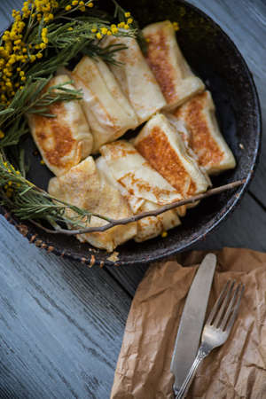 on wooden white background pancakes on a plateの写真素材