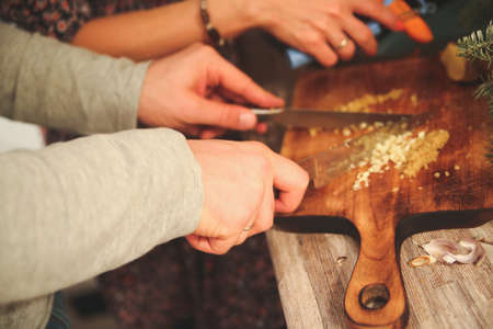 cutting vegetables on a wooden Board with men's handsの写真素材