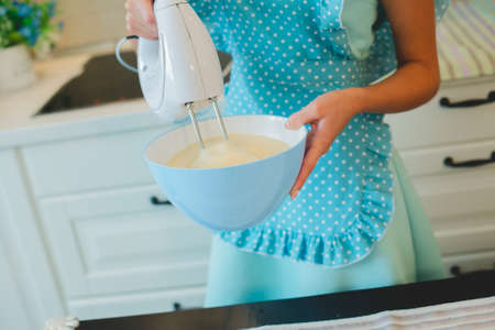 whisking eggs in a bowl for bakingの写真素材