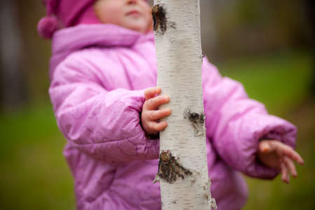 child in autumn Park playing with leavesの写真素材