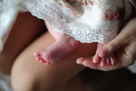 baby foot in the hands of parents