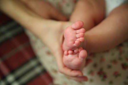 baby foot in the hands of parentsの写真素材