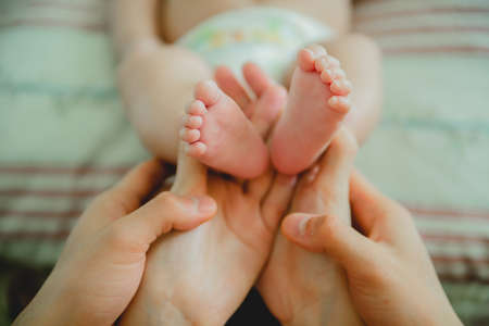 baby foot in the hands of parentsの写真素材