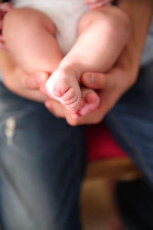 baby foot in the hands of parents
