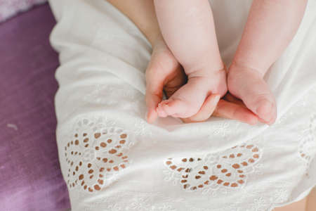baby foot in the hands of parents