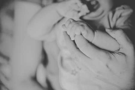 baby foot in the hands of parentsの写真素材