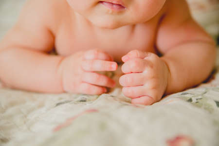 father and mother hold in their hands a little newborn baby'sの写真素材