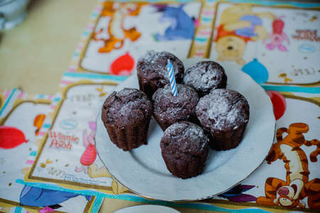 muffins closeup on a plate with a candleの写真素材