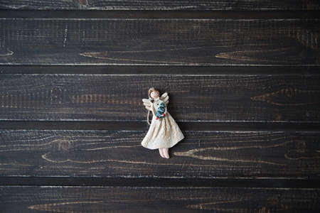 Christmas toy angel lying on the backgroundの写真素材