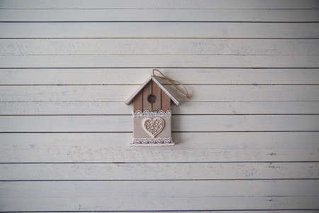 the toy house is in the background, can be hung by the rope