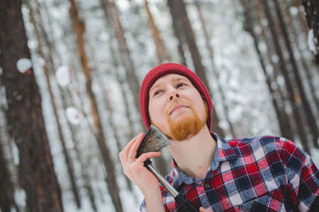 birch winter forest man with axeの写真素材
