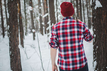 birch winter forest man with axeの写真素材